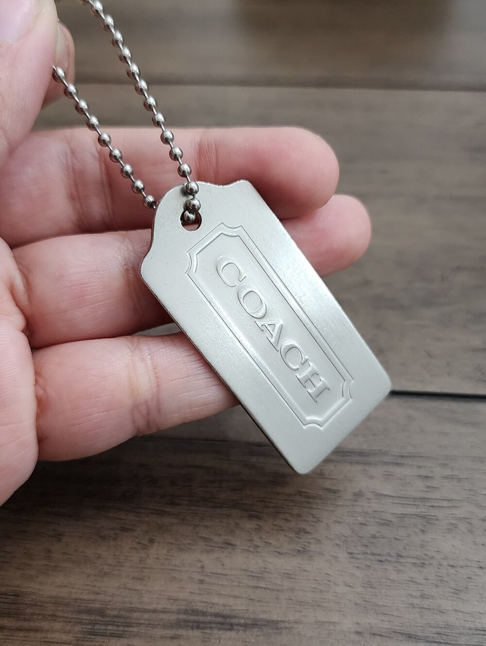 Coach Silver-Tone Embossed Hang Tag